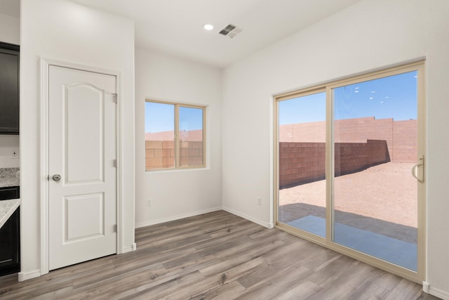 spare room featuring recessed lighting, baseboards, visible vents, and light wood-style floors