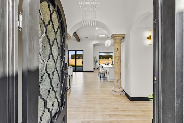 7805 Aguila St NW, Albuquerque, NM 87120 - entrance foyer with light wood-style flooring, arched walkways, baseboards, recessed lighting, and ornate columns