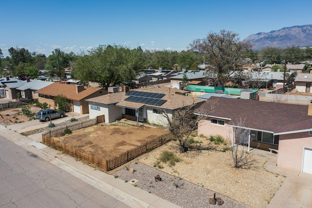 birds eye view of property with a mountain view and a residential view