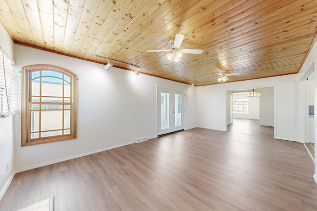 empty room featuring wood ceiling, rail lighting, wood finished floors, and ceiling fan with notable chandelier