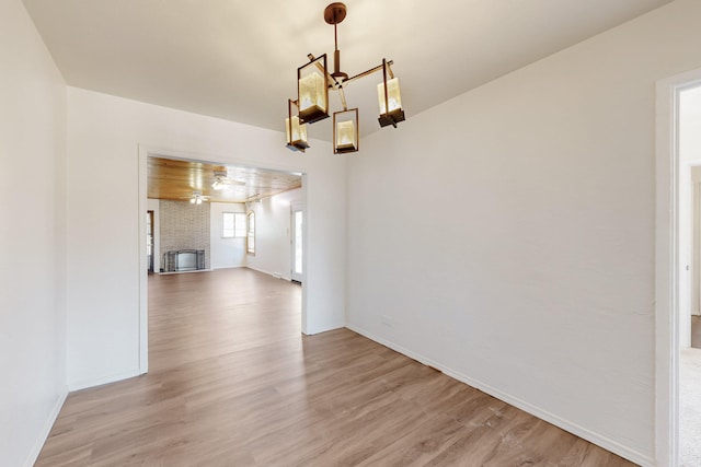 unfurnished dining area featuring light wood-style floors and baseboards