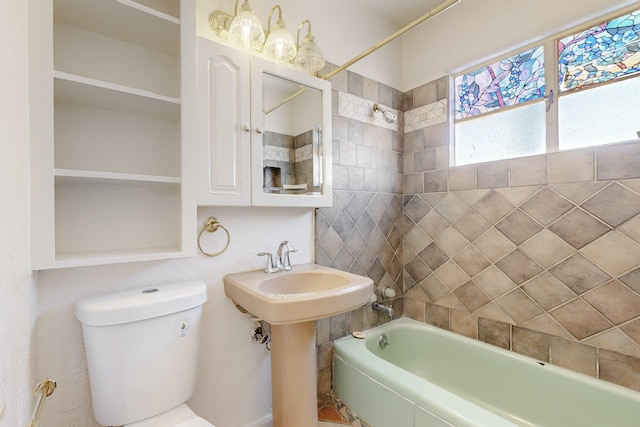bathroom with toilet and bathing tub / shower combination