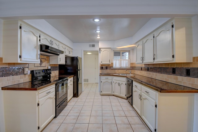 kitchen with a sink, under cabinet range hood, decorative backsplash, black appliances, and white cabinets