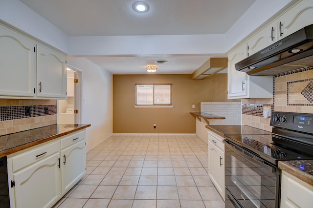 kitchen with electric range, dark countertops, white cabinets, and under cabinet range hood