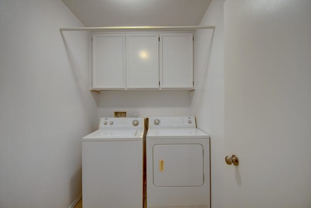 laundry room featuring cabinet space and separate washer and dryer