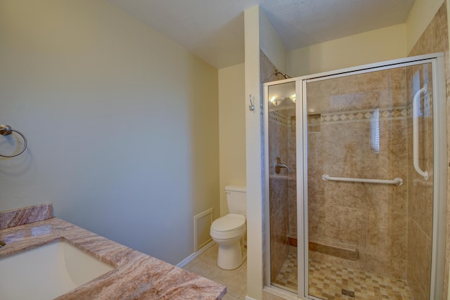 bathroom featuring toilet, a stall shower, tile patterned flooring, and vanity