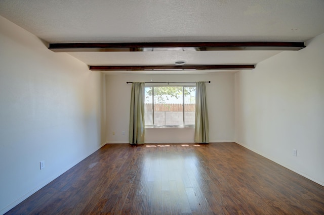 spare room featuring a textured ceiling, baseboards, beam ceiling, and dark wood-type flooring