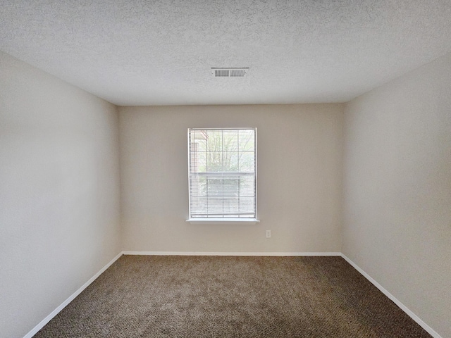 unfurnished room with visible vents, carpet flooring, and baseboards