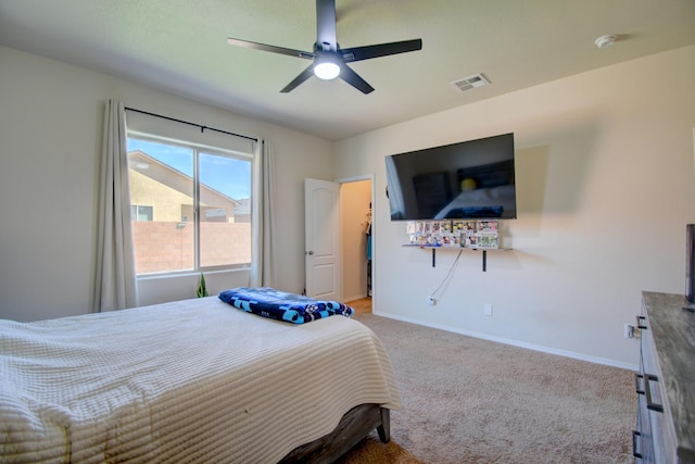 bedroom with baseboards, visible vents, a ceiling fan, and light carpet