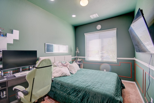carpeted bedroom featuring recessed lighting, visible vents, and wainscoting