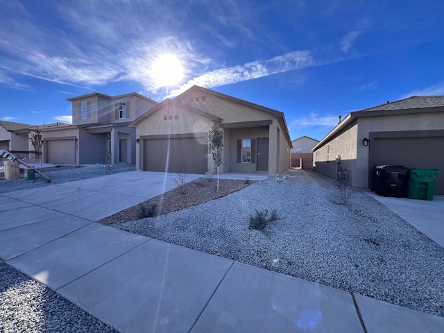 view of front facade with stucco siding, driveway, and an attached garage