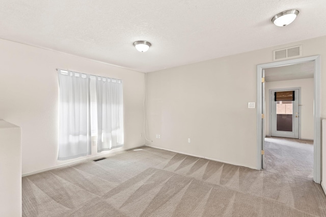 10515 Bilboa St NW, Albuquerque, NM 87114 - empty room with a textured ceiling, visible vents, carpet flooring, and baseboards