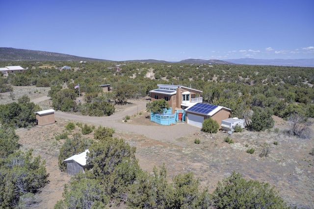birds eye view of property featuring a mountain view and a wooded view