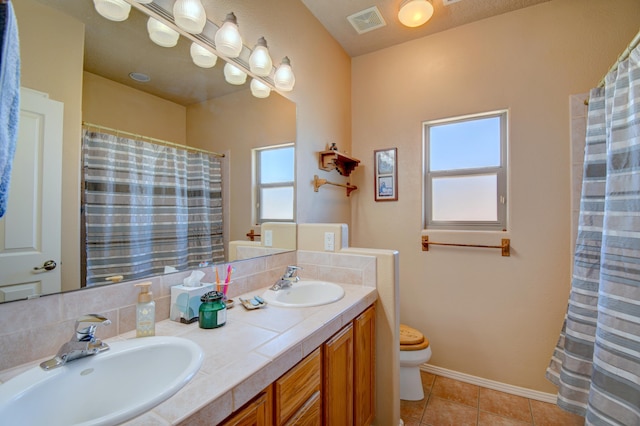 full bath with visible vents, toilet, tile patterned flooring, and a sink