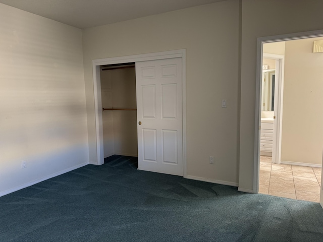 unfurnished bedroom featuring a closet, carpet flooring, and baseboards