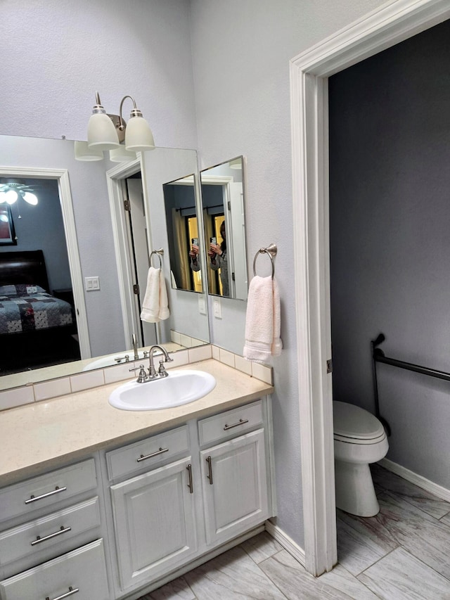 3404 Esplanade Pl SE, Rio Rancho, NM 87124 - bathroom featuring connected bathroom, vanity, toilet, and baseboards
