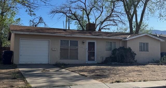 10509 San Jacinto Ave NE, Albuquerque, NM 87112 - single story home featuring concrete driveway, stucco siding, a chimney, and a garage