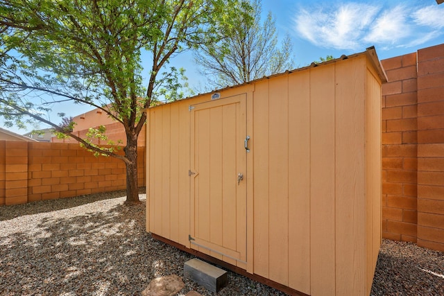 view of shed featuring fence