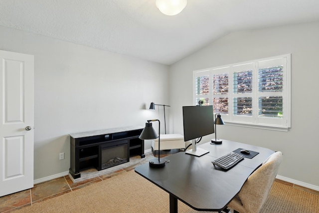 office with lofted ceiling and baseboards