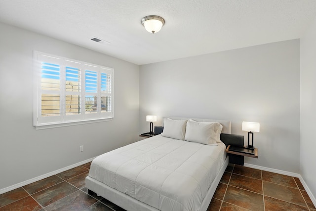 bedroom with visible vents and baseboards