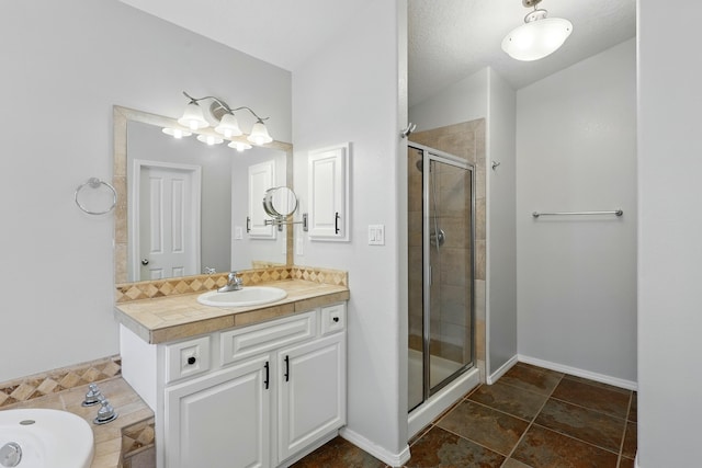 bathroom with vanity and a shower stall
