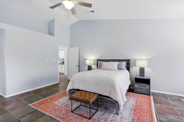 bedroom with stone tile floors, visible vents, and baseboards