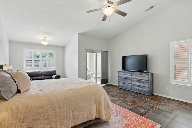 bedroom with baseboards, visible vents, a ceiling fan, and lofted ceiling