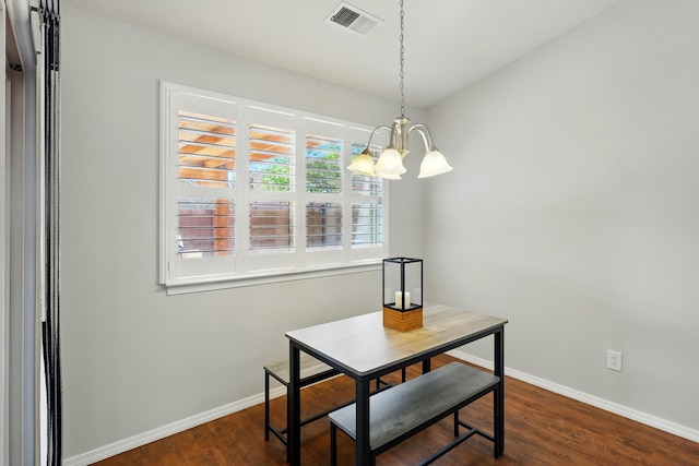 dining space featuring a notable chandelier, baseboards, dark wood-style flooring, and visible vents