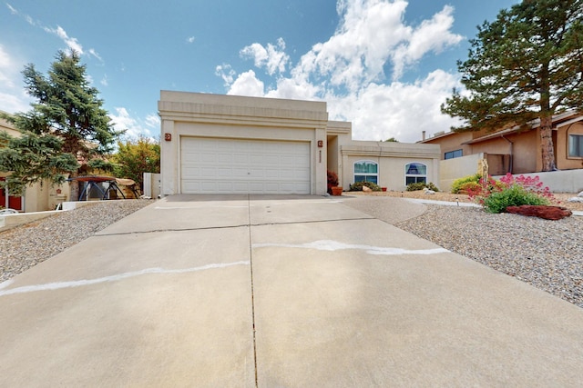 4532 Habershaw Rd NW, Albuquerque, NM 87120 - view of front of home with concrete driveway, an attached garage, and stucco siding