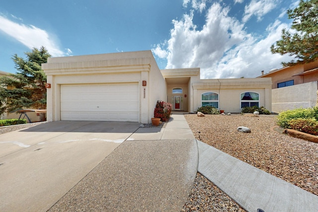 4532 Habershaw Rd NW, Albuquerque, NM 87120 - southwest-style home with driveway, stucco siding, and a garage