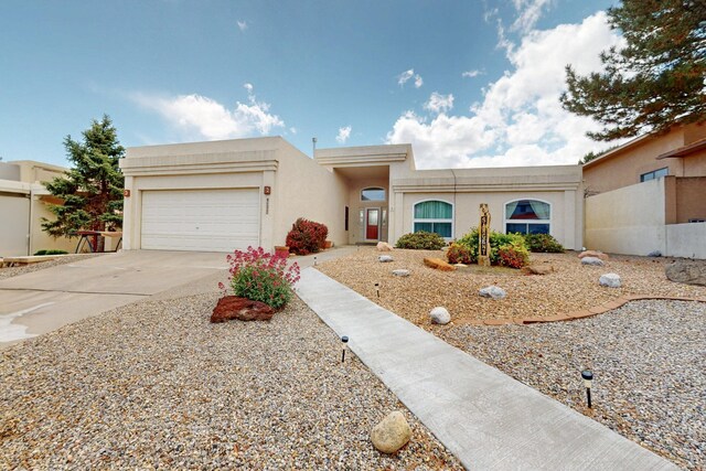 4532 Habershaw Rd NW, Albuquerque, NM 87120 - view of front of house featuring concrete driveway, stucco siding, and an attached garage