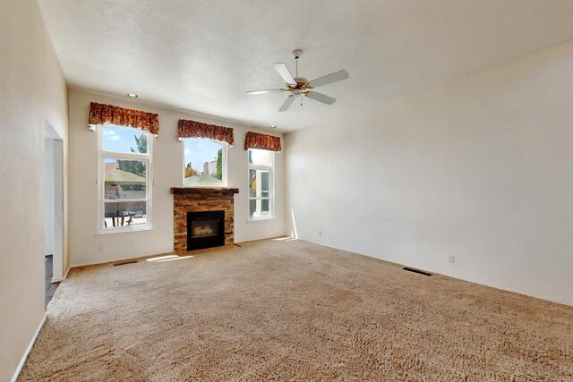 4532 Habershaw Rd NW, Albuquerque, NM 87120 - unfurnished living room with carpet flooring, a ceiling fan, and a fireplace