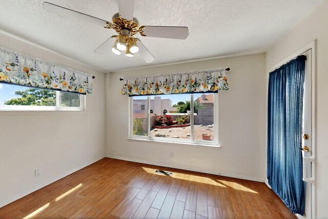4532 Habershaw Rd NW, Albuquerque, NM 87120 - unfurnished dining area with wood finished floors, baseboards, and a ceiling fan