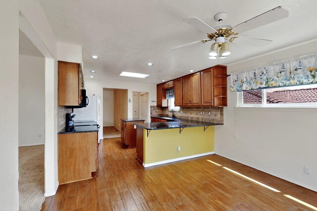 4532 Habershaw Rd NW, Albuquerque, NM 87120 - kitchen featuring a sink, open shelves, a peninsula, dark countertops, and tasteful backsplash