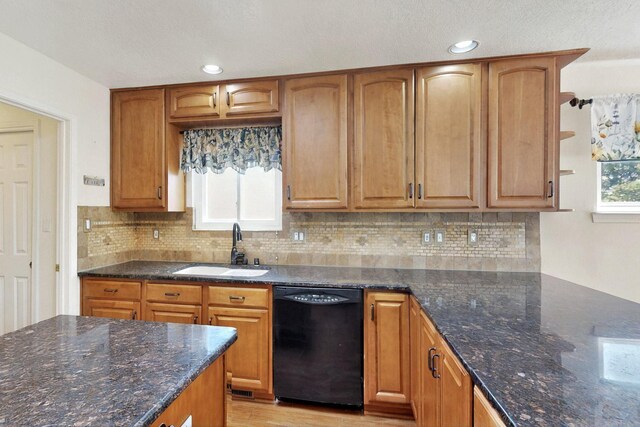 4532 Habershaw Rd NW, Albuquerque, NM 87120 - kitchen featuring black dishwasher, a sink, dark stone countertops, decorative backsplash, and recessed lighting