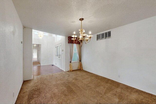 4532 Habershaw Rd NW, Albuquerque, NM 87120 - unfurnished dining area featuring a chandelier, carpet floors, and a textured ceiling