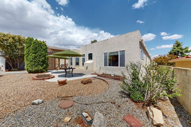 4532 Habershaw Rd NW, Albuquerque, NM 87120 - back of property with stucco siding, a fenced backyard, and a patio area