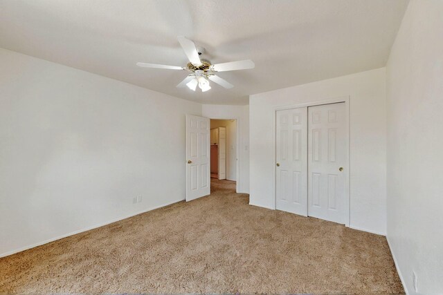 4532 Habershaw Rd NW, Albuquerque, NM 87120 - unfurnished bedroom with carpet flooring, a closet, ceiling fan, and baseboards