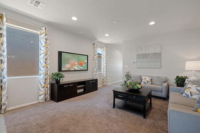 living area featuring recessed lighting, carpet floors, visible vents, and baseboards