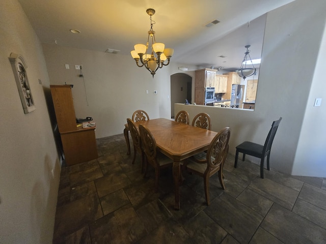 4505 Driftwood Ave NW, Albuquerque, NM 87114 - dining area with arched walkways, a chandelier, and dark stone finish floors