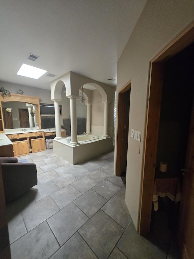 4505 Driftwood Ave NW, Albuquerque, NM 87114 - full bathroom with ornate columns, vanity, tile patterned floors, and a tub