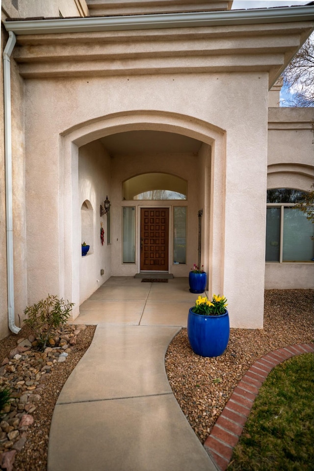 entrance to property featuring stucco siding