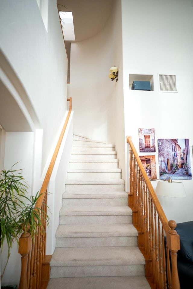 stairway featuring visible vents