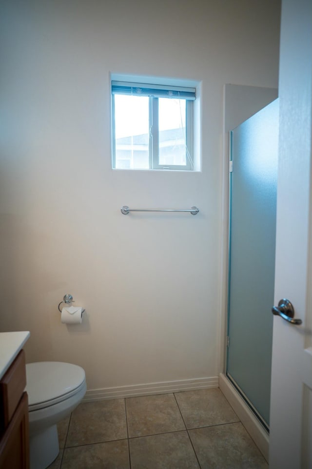 full bath with vanity, tile patterned floors, toilet, baseboards, and a shower with door