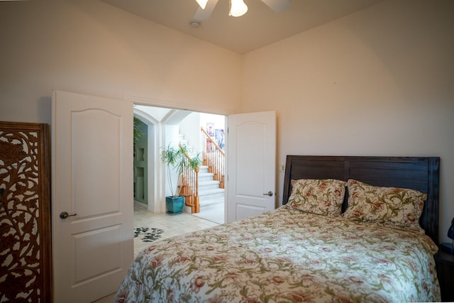tiled bedroom with a ceiling fan