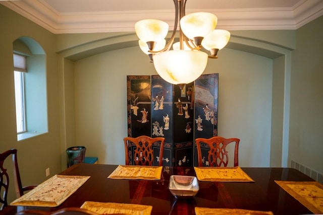 dining room with visible vents, arched walkways, an inviting chandelier, and ornamental molding