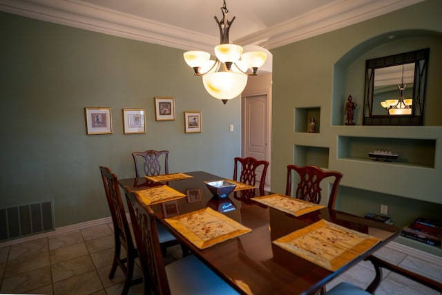tiled dining room with built in shelves, a notable chandelier, visible vents, baseboards, and ornamental molding
