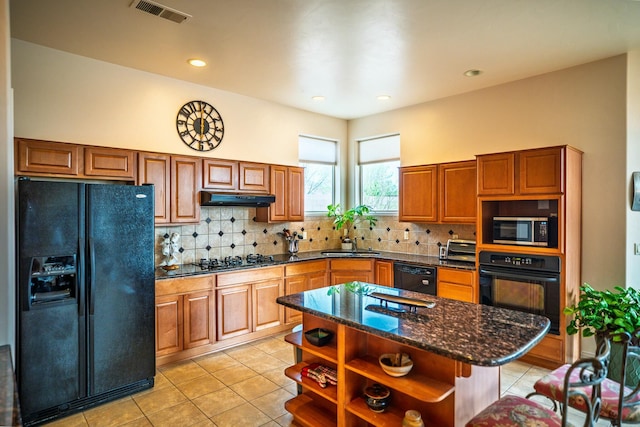 kitchen with open shelves, visible vents, under cabinet range hood, black appliances, and light tile patterned flooring