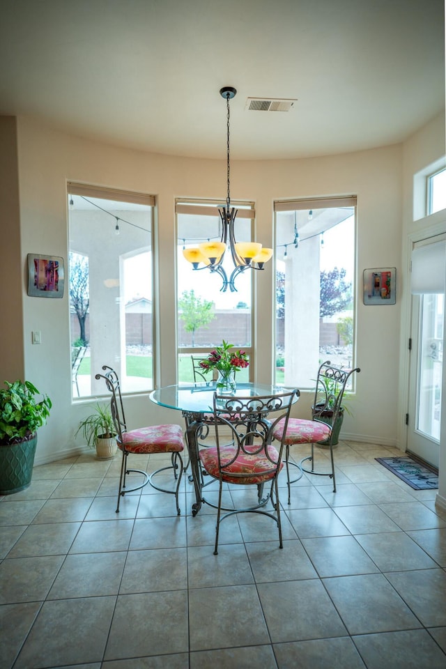 dining space with visible vents, a notable chandelier, tile patterned flooring, and baseboards