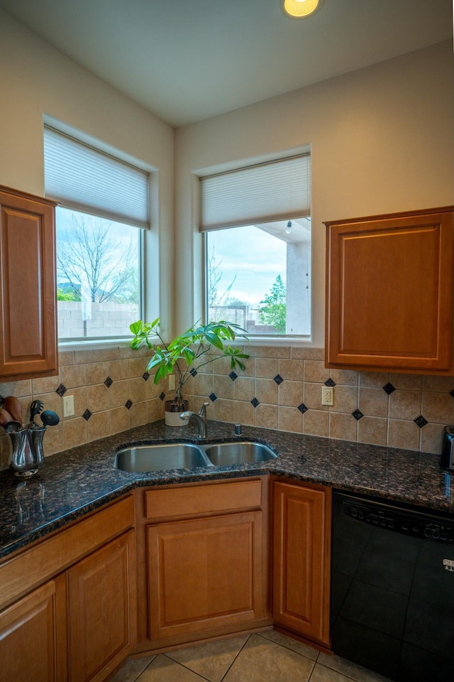 kitchen with a sink, backsplash, dishwasher, and a wealth of natural light